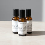 Bottles and jars with labels on a wooden shelf, including 'Handcrafted Magnesium Spray' and 'Pure & Natural Sweet Sleep'.