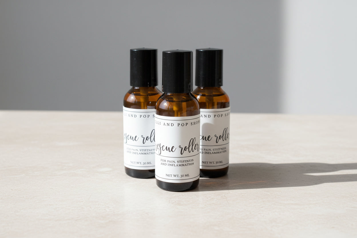 Bottles and jars with labels on a wooden shelf, including 'Handcrafted Magnesium Spray' and 'Pure & Natural Sweet Sleep'.