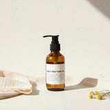 Bottle of 'baby's first body oil' on a light background