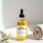Bottle of daily moisturizing serum with dropper on a light background