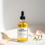 Bottle of daily moisturizing serum with dropper on a light background