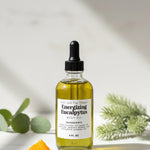 Bottle of 'Energizing Eucalyptus' oil on a light background