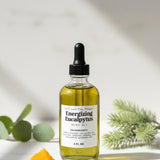 Bottle of 'Energizing Eucalyptus' oil on a light background