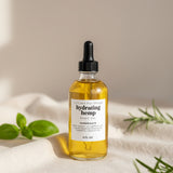 Bottle of hydrating hemp body oil on a neutral background