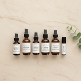 Set of six skincare bottles with labels on a beige background