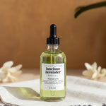 Bottle of luscious lavender body oil on a neutral background