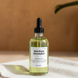 Set of skincare bottles on a tray with a white orchid in the background