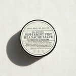 tin with label of peppermint pine headache salve
