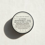 tin with label of peppermint pine headache salve
