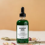 Bottle of 'summer skin' body oil with a dropper on a beige background