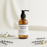 Bottle of 'sweet dreams' baby oil on a light background